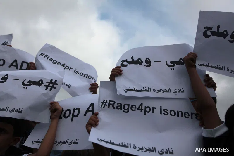Palestinian children hold placards during a Demonstration to show solidarity with Palestinian prisoners held in Israeli jails, in Gaza city on May 28, 2014. Some 120 Palestinians jailed without trial in Israel have been...