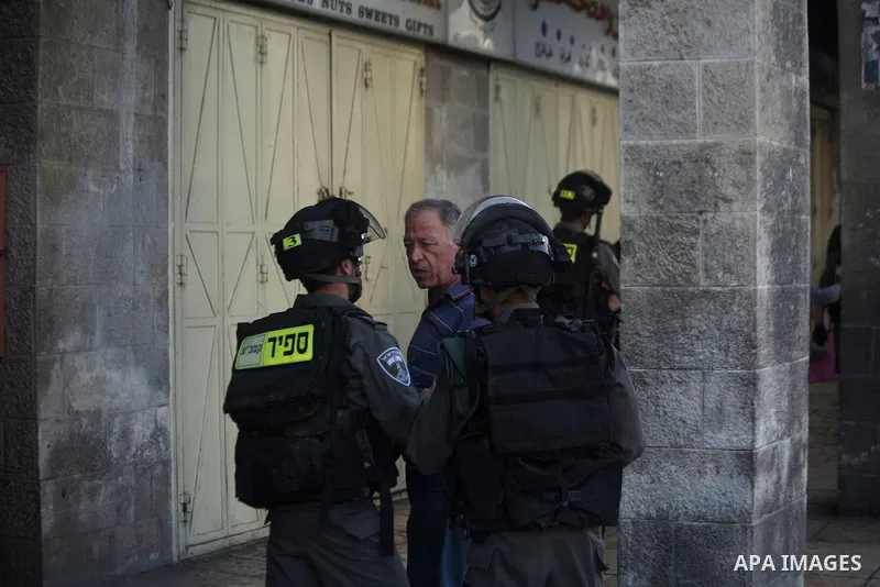 Israeli border guards detain a Palestinian man as Ultra-nationalist Israelis take part in the "flag march" through Damascus Gate in east Jerusalem on May 28, 2014 celebrating the anniversary of its capture in the 1967 Si...
