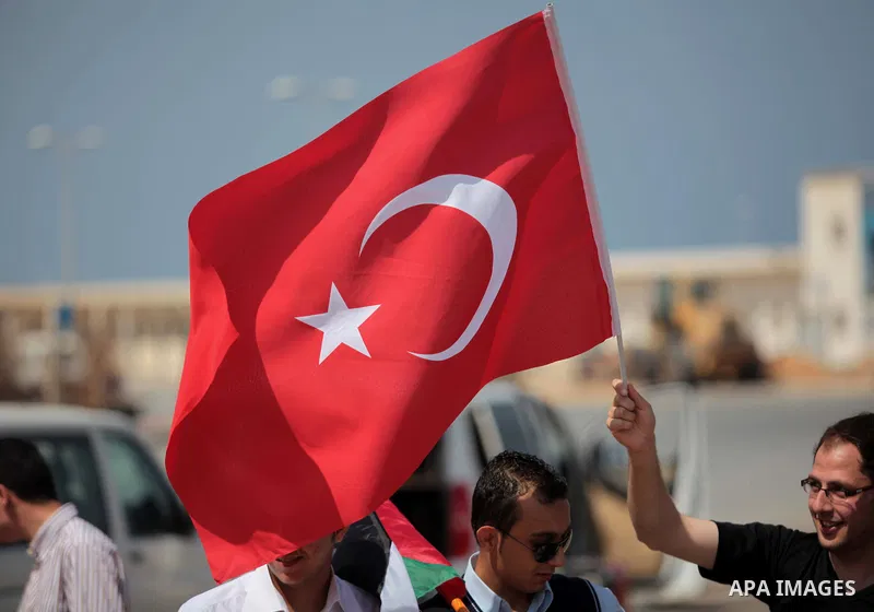 Palestinian men hold a Turkish flag during a rally ahead of the 4th anniversary of the Mavi Marmara Gaza flotilla incident, at the seaport of Gaza City May 29, 2014. Nine activists, eight Turkish and one Turkish-American...