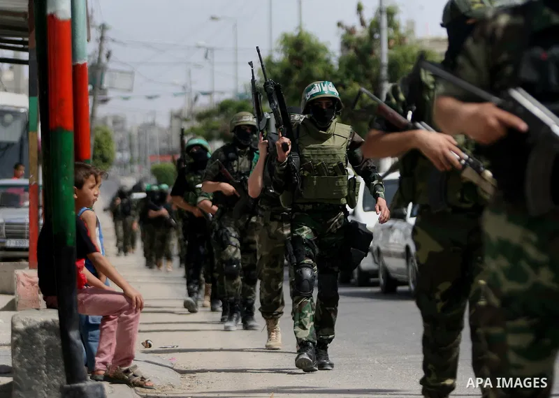 Palestinian militants of the Ezzedine al-Qassam Brigades, Hamas's armed wing, parade in Rafah, southern Gaza Strip, on May 29, 2014. Palestinian president Mahmud Abbas sent a "letter of designation" to Rami Hamdallah, wh...