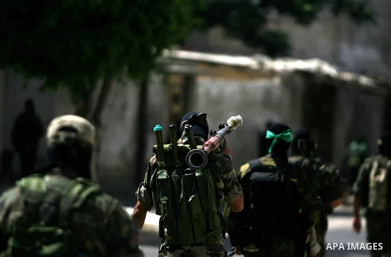 Palestinian militants of the Ezzedine al-Qassam Brigades, Hamas's armed wing, parade in Rafah, southern Gaza Strip, on May 29, 2014. Palestinian president Mahmud Abbas sent a "letter of designation" to Rami Hamdallah, wh...