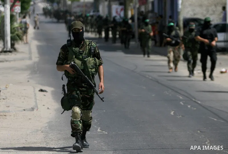 Palestinian militants of the Ezzedine al-Qassam Brigades, Hamas's armed wing, parade in Rafah, southern Gaza Strip, on May 29, 2014. Palestinian president Mahmud Abbas sent a "letter of designation" to Rami Hamdallah, wh...