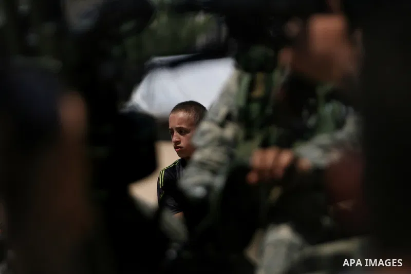 Palestinian militants of the Ezzedine al-Qassam Brigades, Hamas's armed wing, parade in Rafah, southern Gaza Strip, on May 29, 2014. Palestinian president Mahmud Abbas sent a "letter of designation" to Rami Hamdallah, wh...