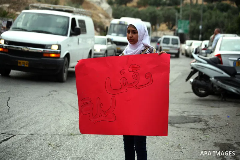 A Palestinian girl holds a banner during a protest to solidarity with Palestinian prisoners, in the East Jerusalem neighborhood of Silwan on May 29, 2014. It was about 120 Palestinians imprisoned without trial in Israel...