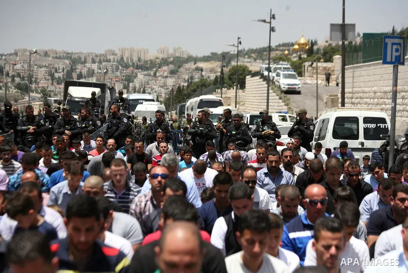 Palestinian Muslim worshipers attend the Friday prayers in the East Jerusalem neighbourhood of Ras al-Amud after being refused entry into the Al-Aqsa compound in Jerusalem, 30 May 2014. The Israeli police restricted the...