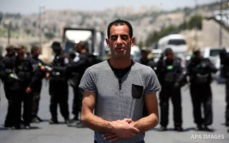 A Palestinian Muslim worshiper attends the Friday prayers in the East Jerusalem neighbourhood of Ras al-Amud after being refused entry into the Al-Aqsa compound in Jerusalem, 30 May 2014. The Israeli police restricted th...