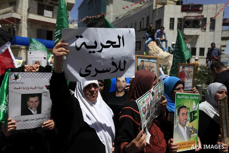 Palestinian supporters of the Hamas movement hold pictures of Palestinian prisoners on hunger strike in Israeli jails during a demonstration in their support in the West Bank city of Ramallah on May 30, 2014. Earlier in...