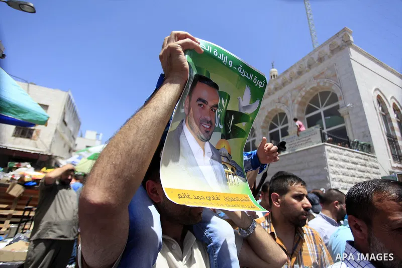 Palestinian supporters of the Hamas movement hold pictures of Palestinian prisoners on hunger strike in Israeli jails during a demonstration in their support in the West Bank city of Ramallah on May 30, 2014. Earlier in...