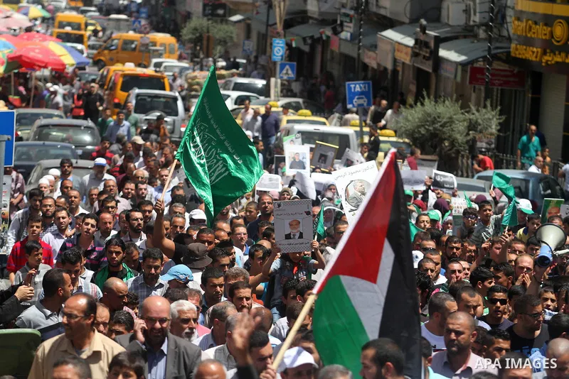 Palestinian supporters of the Hamas movement hold pictures of Palestinian prisoners on hunger strike in Israeli jails during a demonstration in their support in the West Bank city of Ramallah on May 30, 2014. Earlier in...