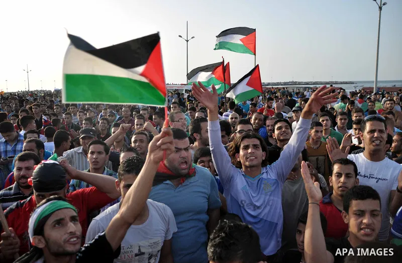 Palestinians watch the match between their national team and the Philippine team during the final of the AFC Challenge Cup in Maldives, in Gaza City on May 30, 2014. Photo by Mohammed Talatene