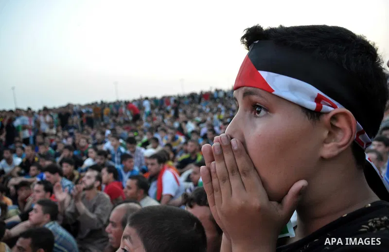 A Palestinian boy reacts as he watches the match between their national team and the Philippine team during the final of the AFC Challenge Cup in Maldives, in Gaza City on May 30, 2014. Photo by Mohammed Talatene