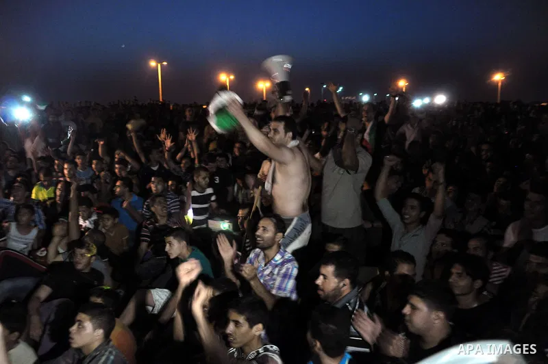 Palestinians celebrate in Gaza City on May 30, 2014, after Palestine qualified for their maiden Asian Cup appearance with a 1-0 win over injury-hit Philippines in the final of the AFC Challenge Cup in Maldives. Photo by...