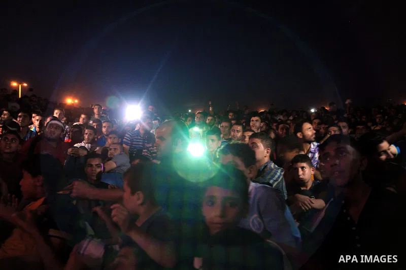 Palestinians celebrate in Gaza City on May 30, 2014, after Palestine qualified for their maiden Asian Cup appearance with a 1-0 win over injury-hit Philippines in the final of the AFC Challenge Cup in Maldives. Photo by...