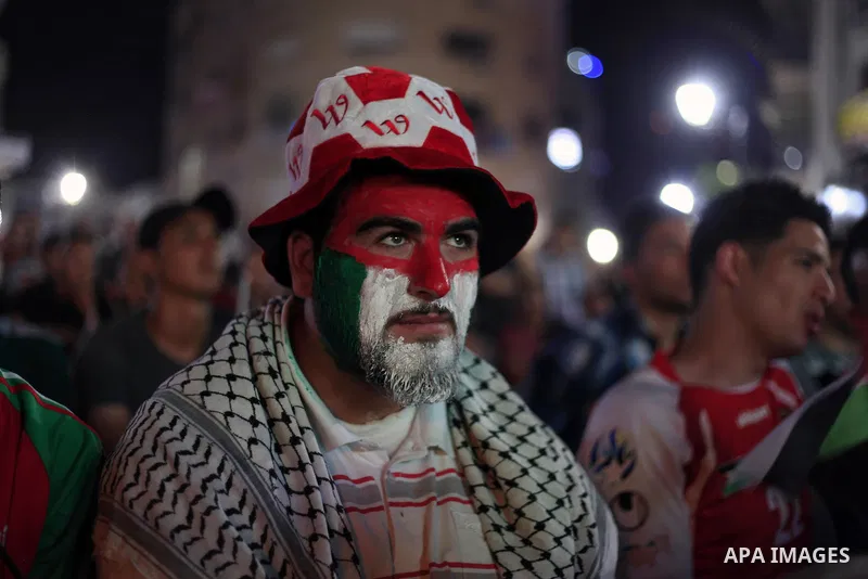 Palestinians watch the match between their national team and the Philippine team during the final of the AFC Challenge Cup in Maldives, in the West Bank city of Ramallah on May 30, 2014. Photo by Issam Rimawi