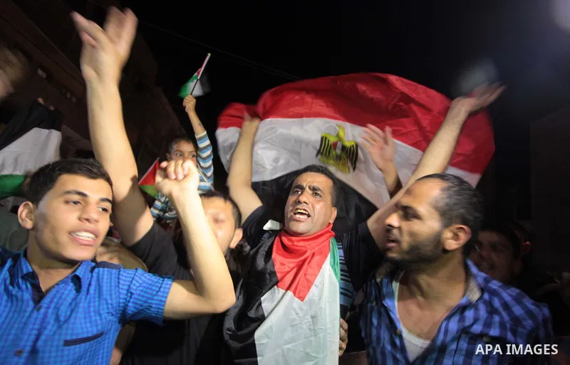 Palestinians celebrate in Gaza City on May 30, 2014, after Palestine qualified for their maiden Asian Cup appearance with a 1-0 win over injury-hit Philippines in the final of the AFC Challenge Cup in Maldives. Photo by...