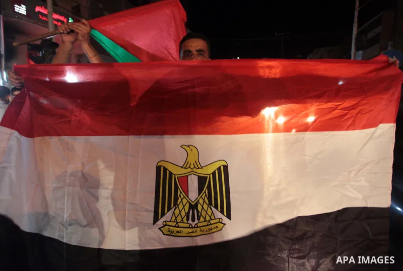 Palestinians celebrate in Gaza City on May 30, 2014, after Palestine qualified for their maiden Asian Cup appearance with a 1-0 win over injury-hit Philippines in the final of the AFC Challenge Cup in Maldives. Photo by...