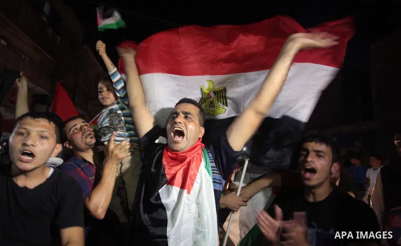Palestinians celebrate in Gaza City on May 30, 2014, after Palestine qualified for their maiden Asian Cup appearance with a 1-0 win over injury-hit Philippines in the final of the AFC Challenge Cup in Maldives. Photo by...