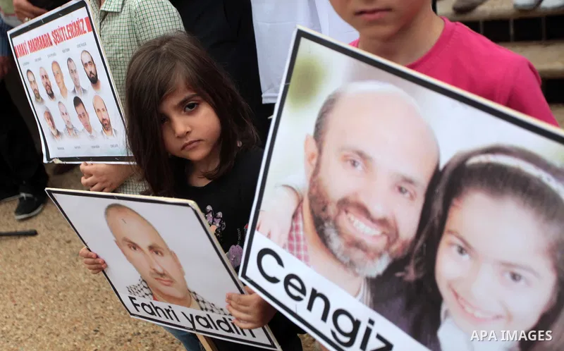 Palestinian children hold photos of people killed on the Mavi Marmara ship, the lead boat of a flotilla headed to the Gaza Strip which was stormed by Israeli naval commandos in a predawn confrontation in the Mediterranea...