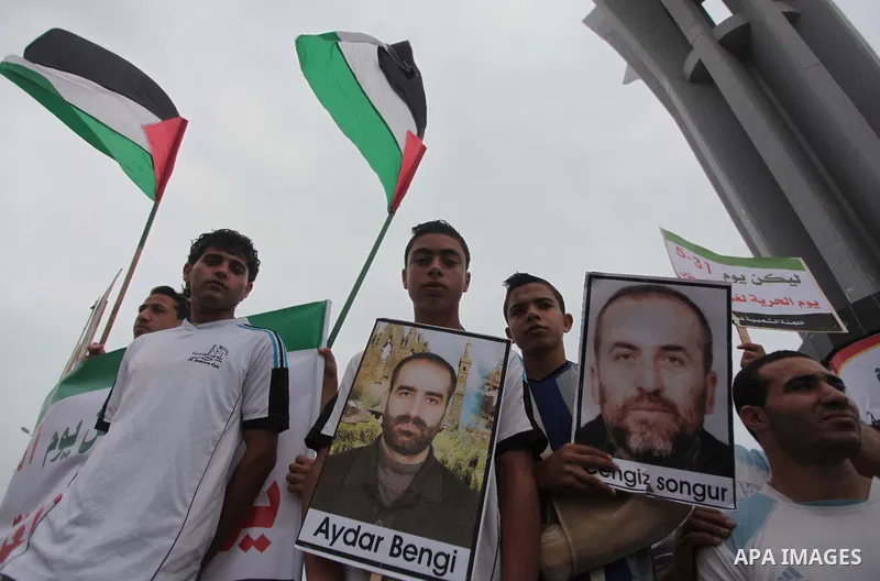 Palestinian youths hold Palestine flags during a rally on the fourth anniversary of the Mavi Marmara Gaza flotilla incident, at the seaport of Gaza City May 31, 2014. Eight Turks and a Turkish-American, died in an Israel...