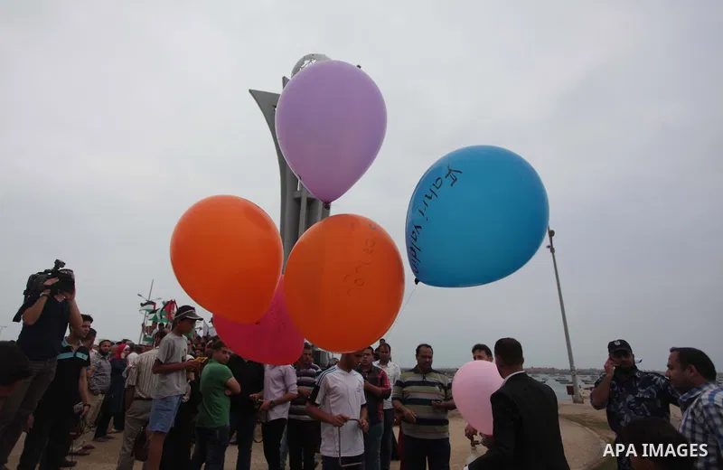 Palestinians hold balloons during a rally on the fourth anniversary of the Mavi Marmara Gaza flotilla incident, at the seaport of Gaza City May 31, 2014. Eight Turks and a Turkish-American, died in an Israeli commando ra...