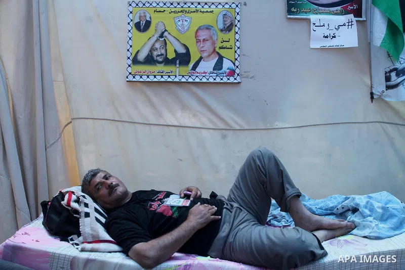 A Palestinian man on hunger strike stays at a tent in front of Red cross office in Gaza City, to solidarity with Palestinian prisoners, on May 31, 2014. It was about 120 Palestinians imprisoned without trial in Israel on...