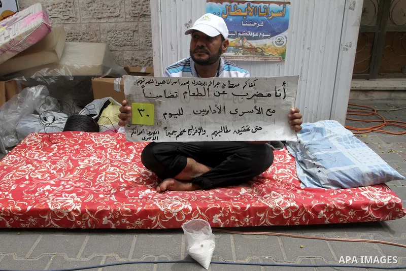 A Palestinian man on hunger strike stays at a tent in front of Red cross office in Gaza City, to solidarity with Palestinian prisoners, on May 31, 2014. It was about 120 Palestinians imprisoned without trial in Israel on...
