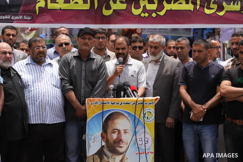 Palestinians speak a press conference at a tent in front of Red cross office in Gaza City, to solidarity with Palestinian prisoners, on May 31, 2014. It was about 120 Palestinians imprisoned without trial in Israel on an...