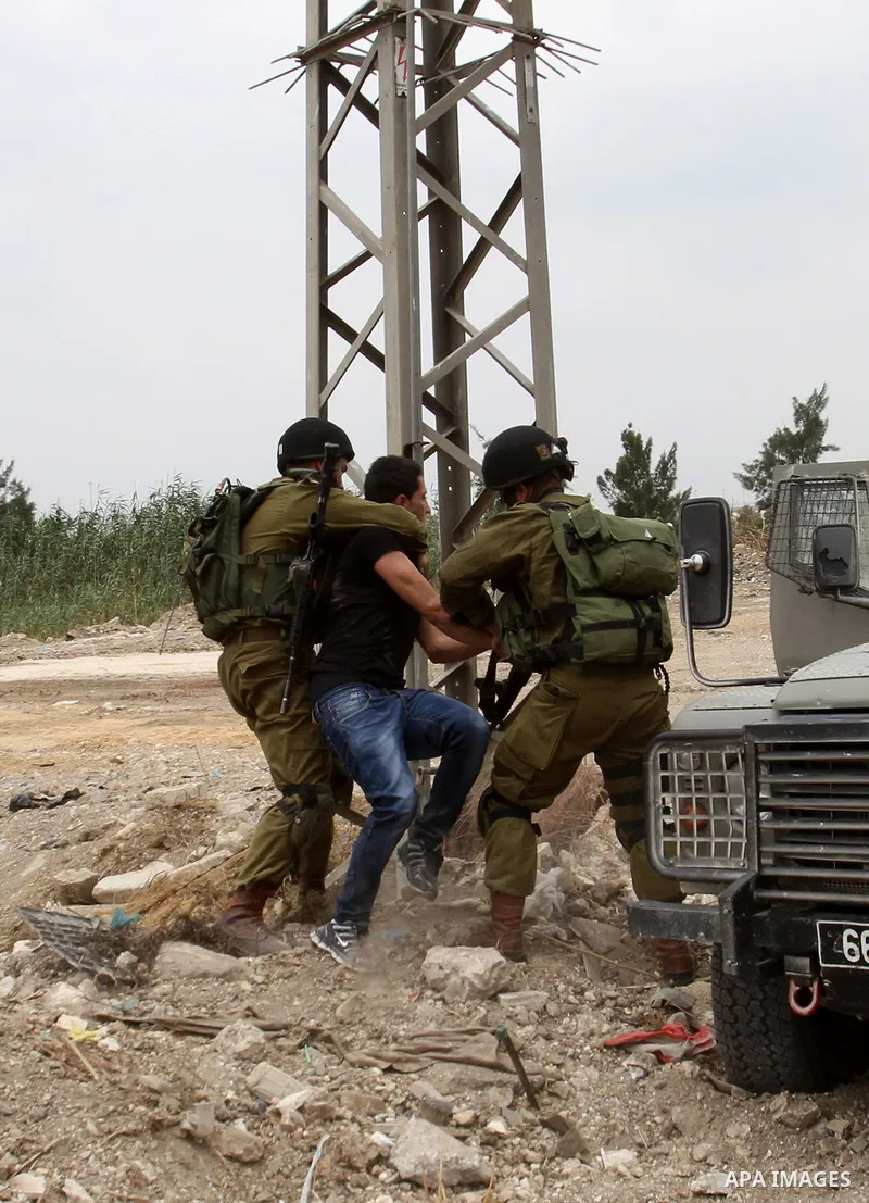 Israeli soldiers wrestle down a Palestinian protester to arrest him during clashes near the West Bank city of Tulkarem, 31 May 2014. Reportedly dozens of Palestinians were injured during clashes with Israeli forces after...