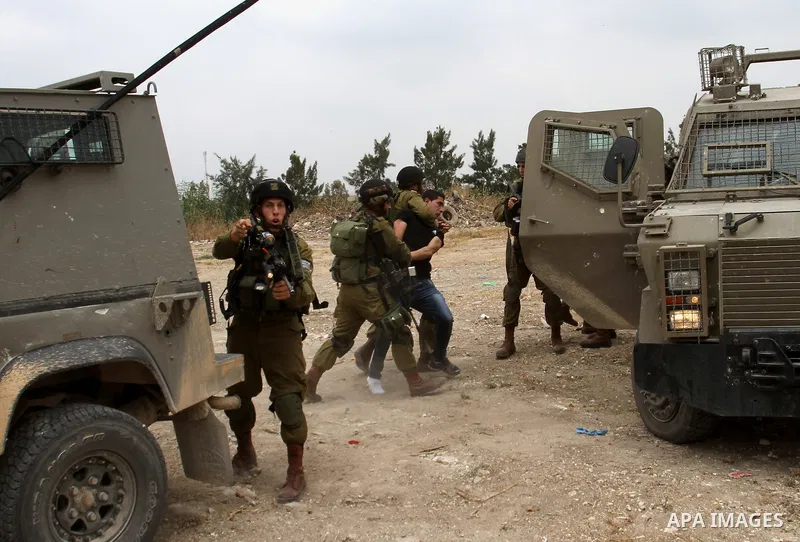 Israeli soldiers wrestle down a Palestinian protester to arrest him during clashes near the West Bank city of Tulkarem, 31 May 2014. Reportedly dozens of Palestinians were injured during clashes with Israeli forces after...