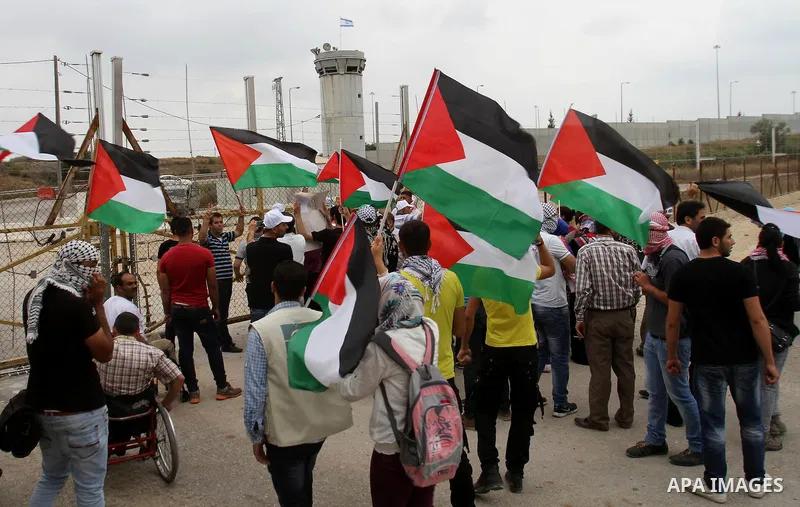 Palestinian protesters wave Palestinian flags during clashes with Israeli forces near the West Bank city of Tulkarem, 31 May 2014. Reportedly dozens of Palestinians were injured during clashes with Israeli forces after p...