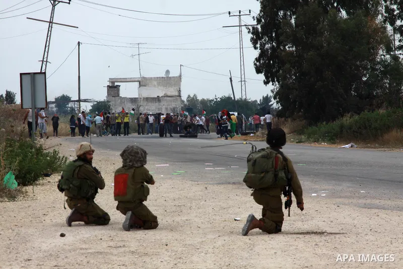 Israeli soldiers fire tear gas at Palestinian protesters responding with stones during clashes near the West Bank city of Tulkarem, 31 May 2014. Reportedly dozens of Palestinians were injured during clashes with Israeli...
