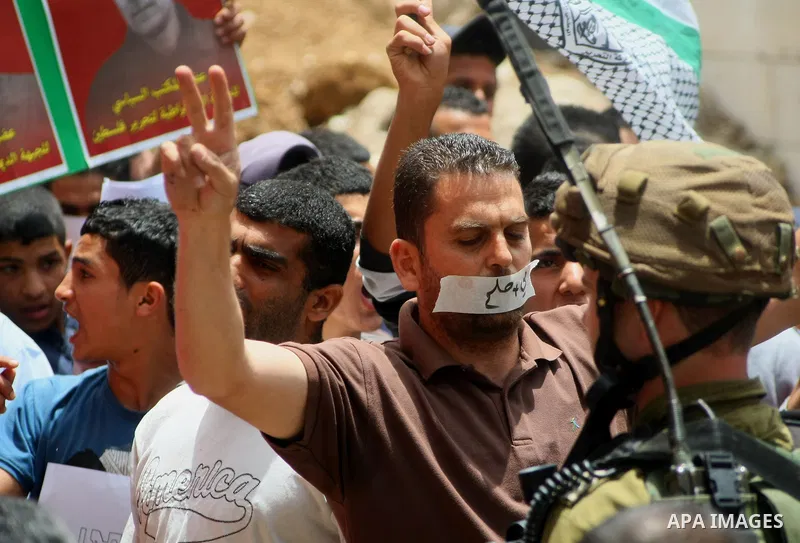 Palestinian Protesters gather to demonstrate in support of Palestinian prisoners on hunger strike in Israeli jails at the al-Aroub Palestinian refugee camp, just north the West Bank town of Hebron on May 31, 2014. Photo...