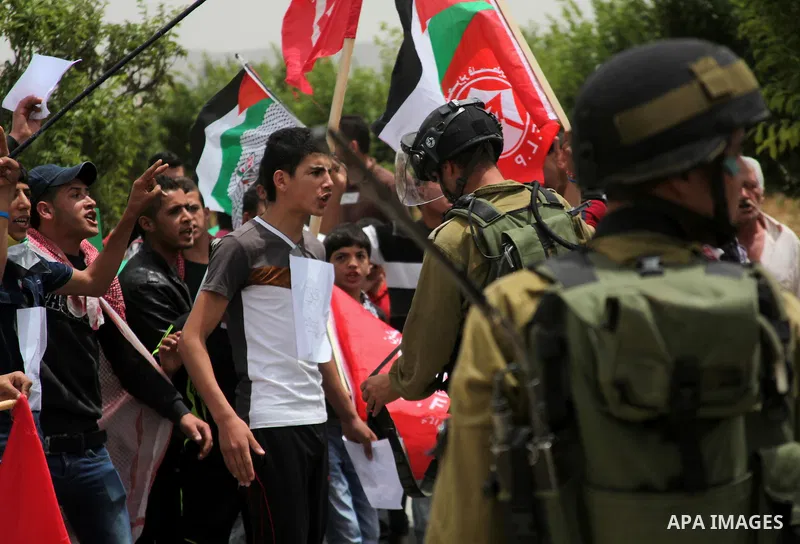 Palestinian Protesters gather to demonstrate in support of Palestinian prisoners on hunger strike in Israeli jails at the al-Aroub Palestinian refugee camp, just north the West Bank town of Hebron on May 31, 2014. Photo...