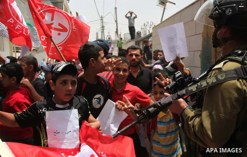 Palestinian Protesters gather to demonstrate in support of Palestinian prisoners on hunger strike in Israeli jails at the al-Aroub Palestinian refugee camp, just north the West Bank town of Hebron on May 31, 2014. Photo...