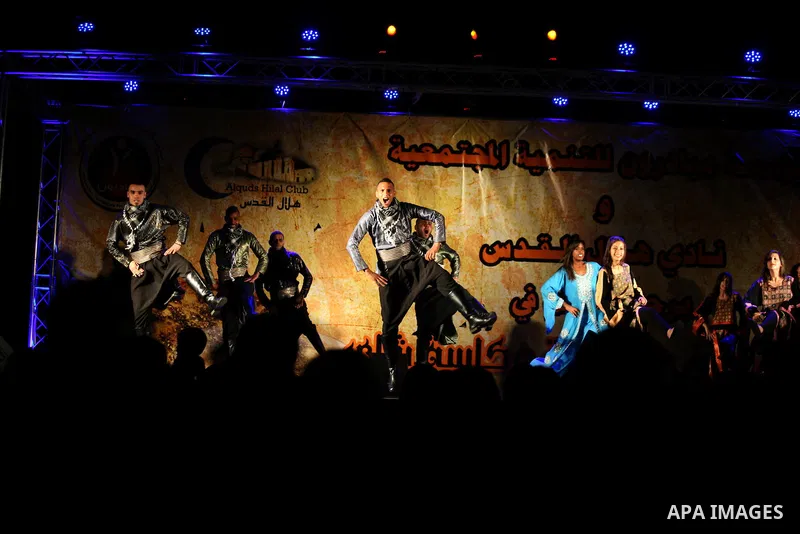 Palestinian youths participate in a festival "Manqusha and tea cup" for the Arts and Heritage, in Jerusalem old city, on May 31, 2014. Photo by Saeed Qaq
