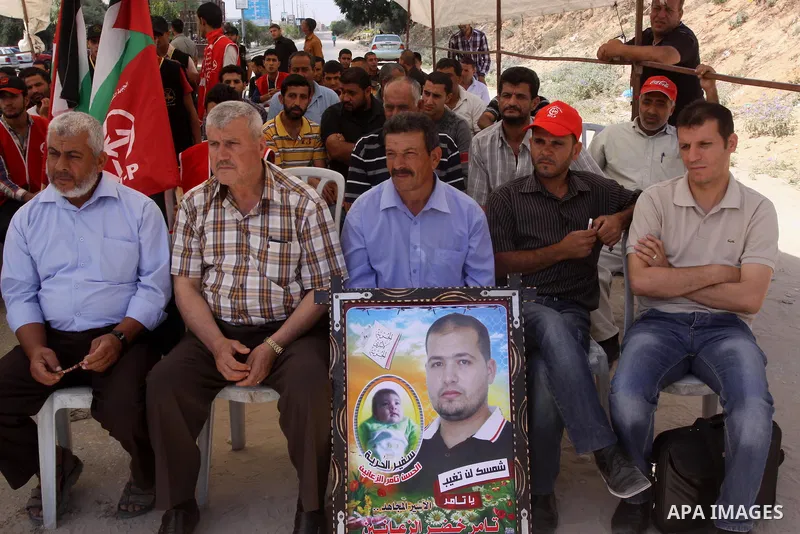 Palestinians take part a protest to solidarity with Palestinian prisoners, at a tent near Erez crossing in the northern Gaza Strip on June 01, 2014. It was about 120 Palestinians imprisoned without trial in Israel on an...