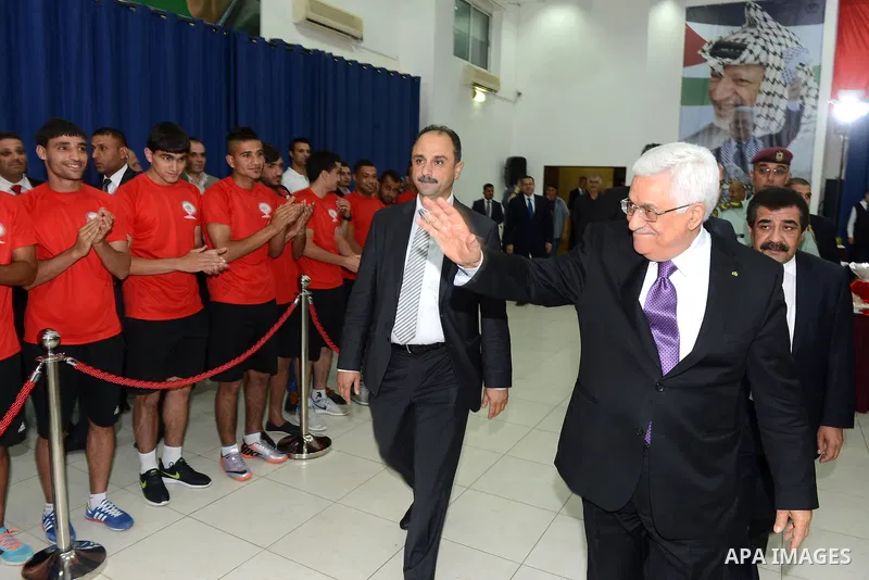 Palestinian President Mahmoud Abbas greets the Palestinian national football team which won the AFC Challenge Cup, at Abbas's office in the West Bank city of Ramallah on June 1, 2014. Palestine qualified for their maiden...