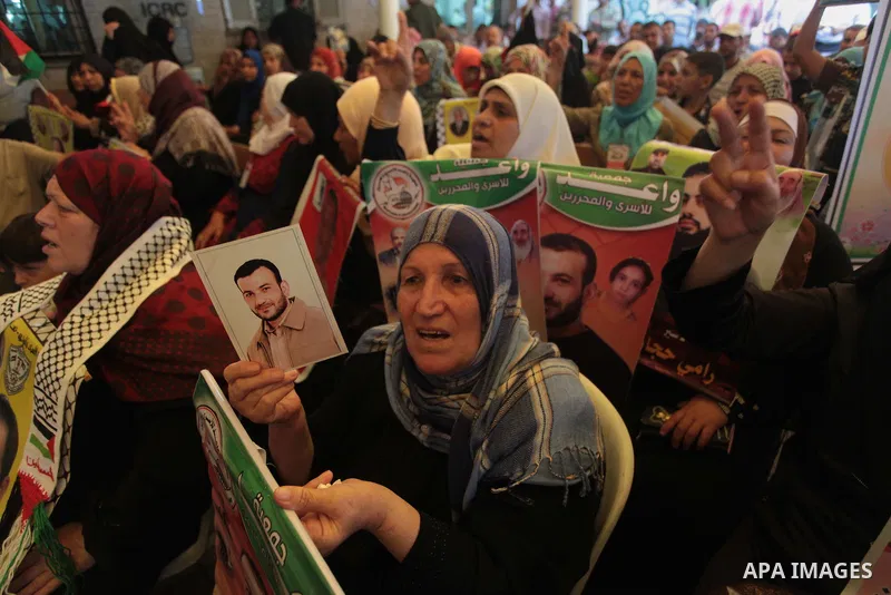 Palestinians hold posters of Prisoners during a rally to show solidarity with Palestinian prisoners held in Israeli jails, in front of Red cross office in Gaza City June 2, 2014. Some 120 Palestinians jailed without tria...