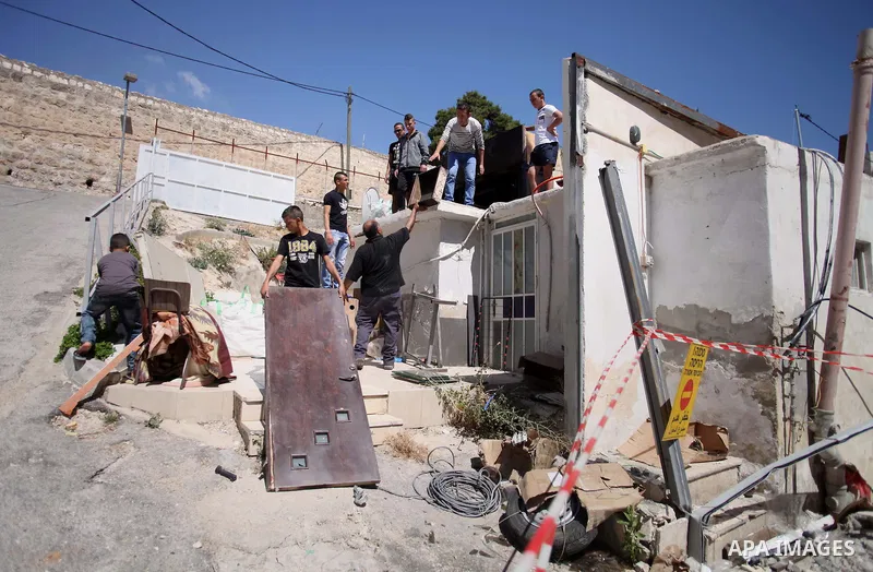 Palestinians inspect their belongings following demolished their sheds by Israeli bulldozers, in al-Tour neighborhood, east Jerusalem on June 02, 2014. Israel destroyed more than 500 Palestinian properties in the West Ba...