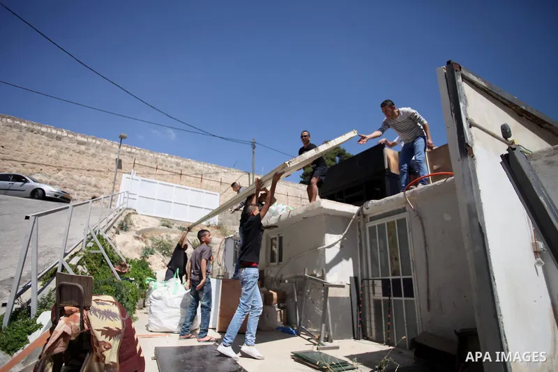 Palestinians inspect their belongings following demolished their sheds by Israeli bulldozers, in al-Tour neighborhood, east Jerusalem on June 02, 2014. Israel destroyed more than 500 Palestinian properties in the West Ba...