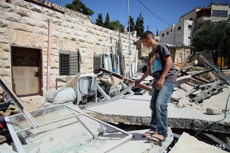 A Palestinian man inspects his belongings following demolished their sheds by Israeli bulldozers, in al-Tour neighborhood, east Jerusalem on June 02, 2014. Israel destroyed more than 500 Palestinian properties in the Wes...