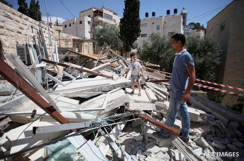 Palestinians inspect their belongings following demolished their sheds by Israeli bulldozers, in al-Tour neighborhood, east Jerusalem on June 02, 2014. Israel destroyed more than 500 Palestinian properties in the West Ba...