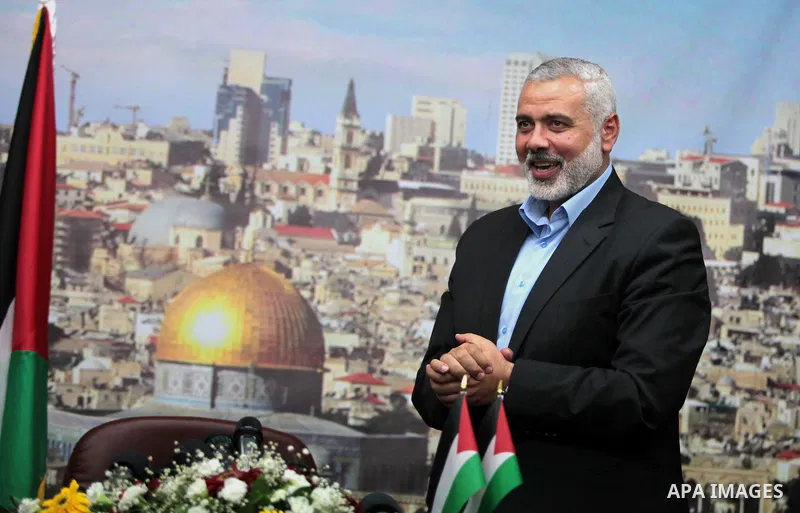 Senior Hamas leader Ismail Haniyeh waves as he leaves his office as a former Hamas government Prime Minister, in Gaza City June 2, 2014. President Mahmoud Abbas swore in a Palestinian unity government on Monday under a r...