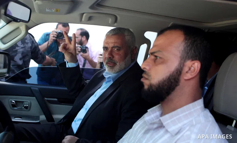 Senior Hamas leader Ismail Haniyeh waves as he leaves his office as a former Hamas government Prime Minister, in Gaza City June 2, 2014. President Mahmoud Abbas swore in a Palestinian unity government on Monday under a r...