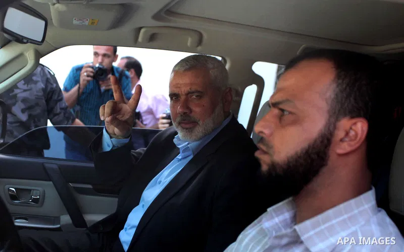 Senior Hamas leader Ismail Haniyeh waves as he leaves his office as a former Hamas government Prime Minister, in Gaza City June 2, 2014. President Mahmoud Abbas swore in a Palestinian unity government on Monday under a r...