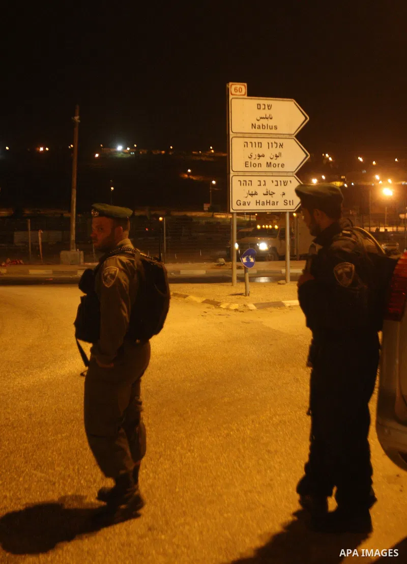 Israeli security forces stand guard at the Zaatara checkpoint after killed a Palestinian man, in the northern West Bank city of Nablus, on June 03, 2014. An Israeli army spokeswoman confirmed the incident, saying that a...