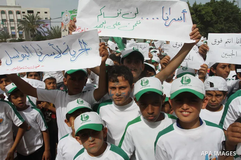 Palestinian children take part in a summer camp organized by Hamas on June 3, 2014. Thousands of elementary school students in the Gaza Strip are going to Hamas summer camps, in which they take part in recreational activ...