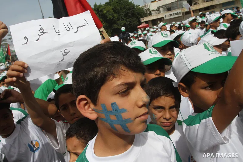 Palestinian children take part in a summer camp organized by Hamas on June 3, 2014. Thousands of elementary school students in the Gaza Strip are going to Hamas summer camps, in which they take part in recreational activ...