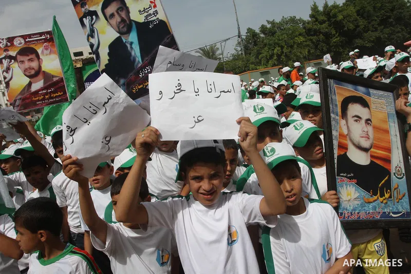 Palestinian children take part in a summer camp organized by Hamas on June 3, 2014. Thousands of elementary school students in the Gaza Strip are going to Hamas summer camps, in which they take part in recreational activ...