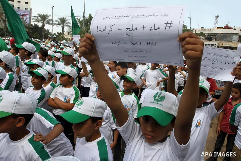 Palestinian children take part in a summer camp organized by Hamas on June 3, 2014. Thousands of elementary school students in the Gaza Strip are going to Hamas summer camps, in which they take part in recreational activ...